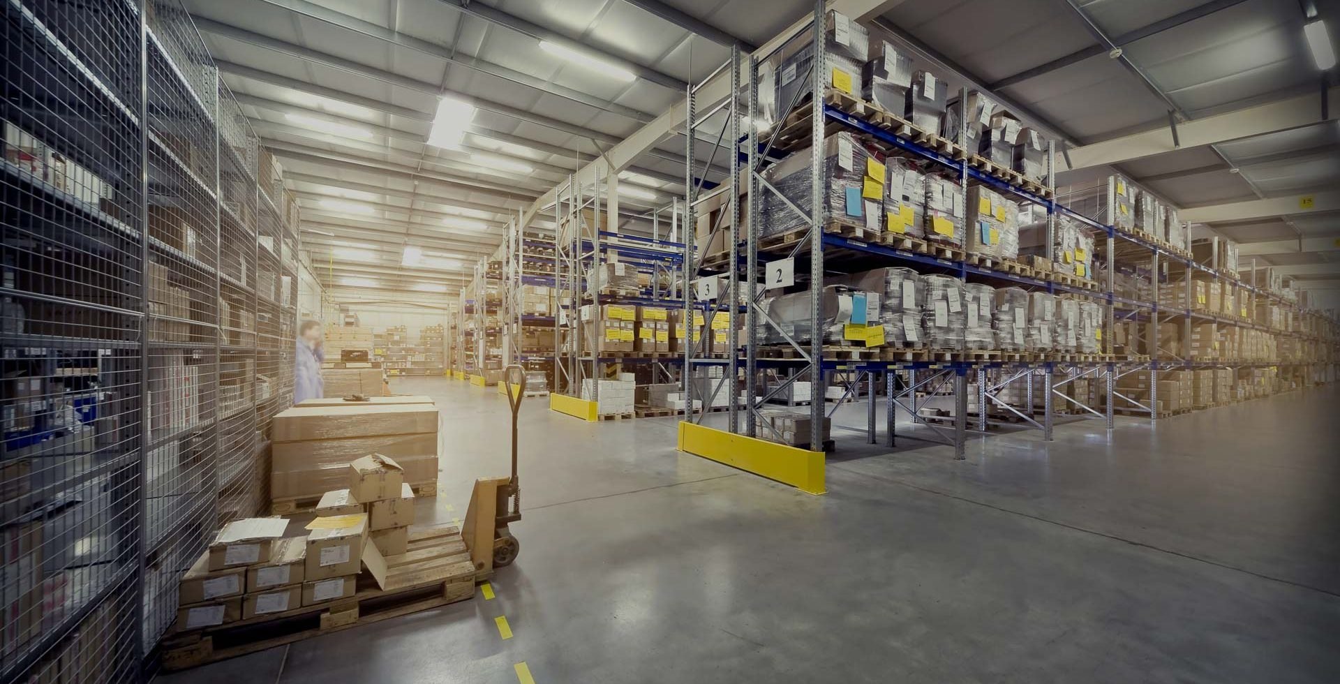 Organized warehouse shelving with tested used industrial automation parts ready to ship